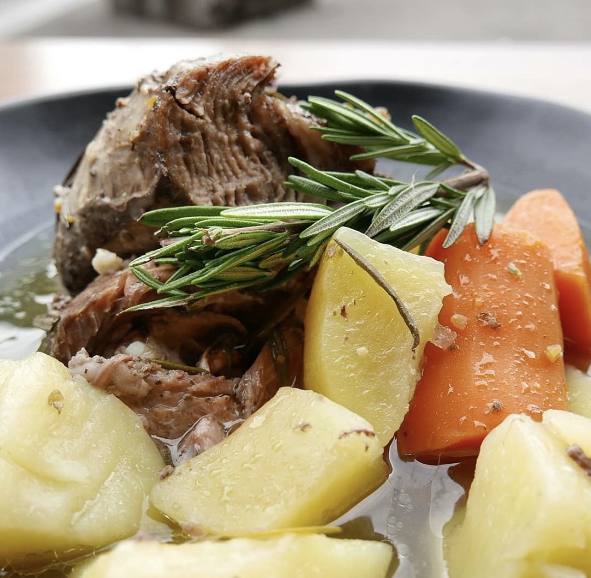 Slow cooked lamb shoulder with potatoes and carrots