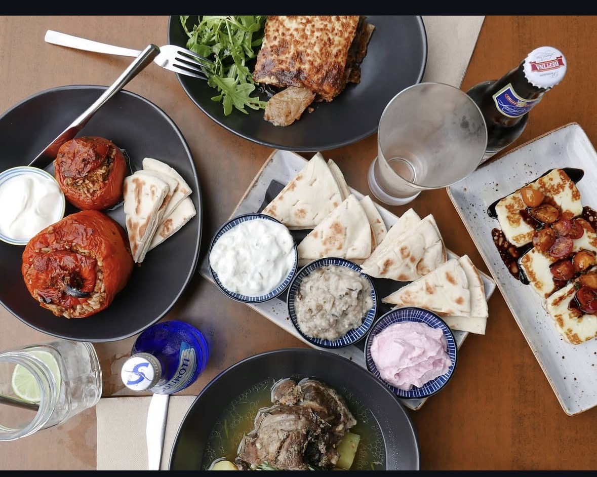 A generous Zupano Mediterranean spread with dips, pita and grilled food